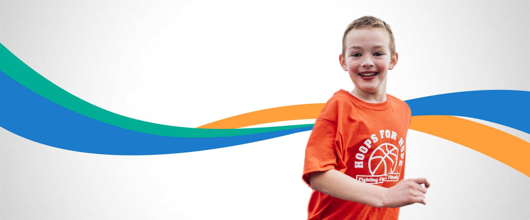 A boy wearing an orange t-shirt.