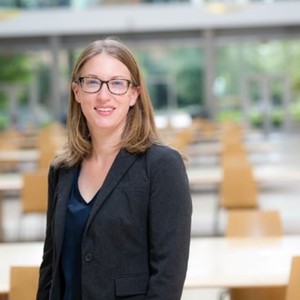 Profile of Dr. Cara Haney standing in front of desks.